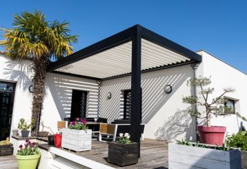 Modern black and white pergolas adorned with climbing plants, showcasing the latest trends in outdoor living spaces in Brentwood.