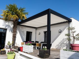 Modern black and white pergolas adorned with climbing plants, showcasing the latest trends in outdoor living spaces in Brentwood.